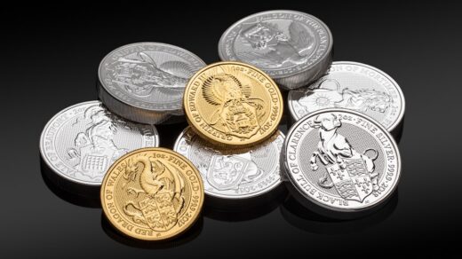 A collection of gold and silver coins arranged on a reflective surface.